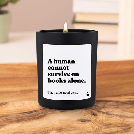 Duftkerze Schwarz Woody A human cannot survive on books alone. They also need cats. von ChattyCandles